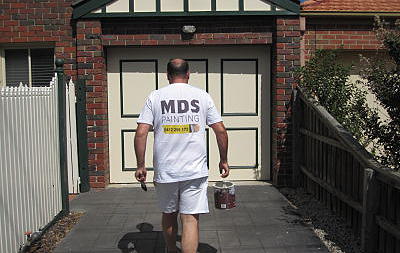 Melbourne painter carrying paint can Melbourne painters